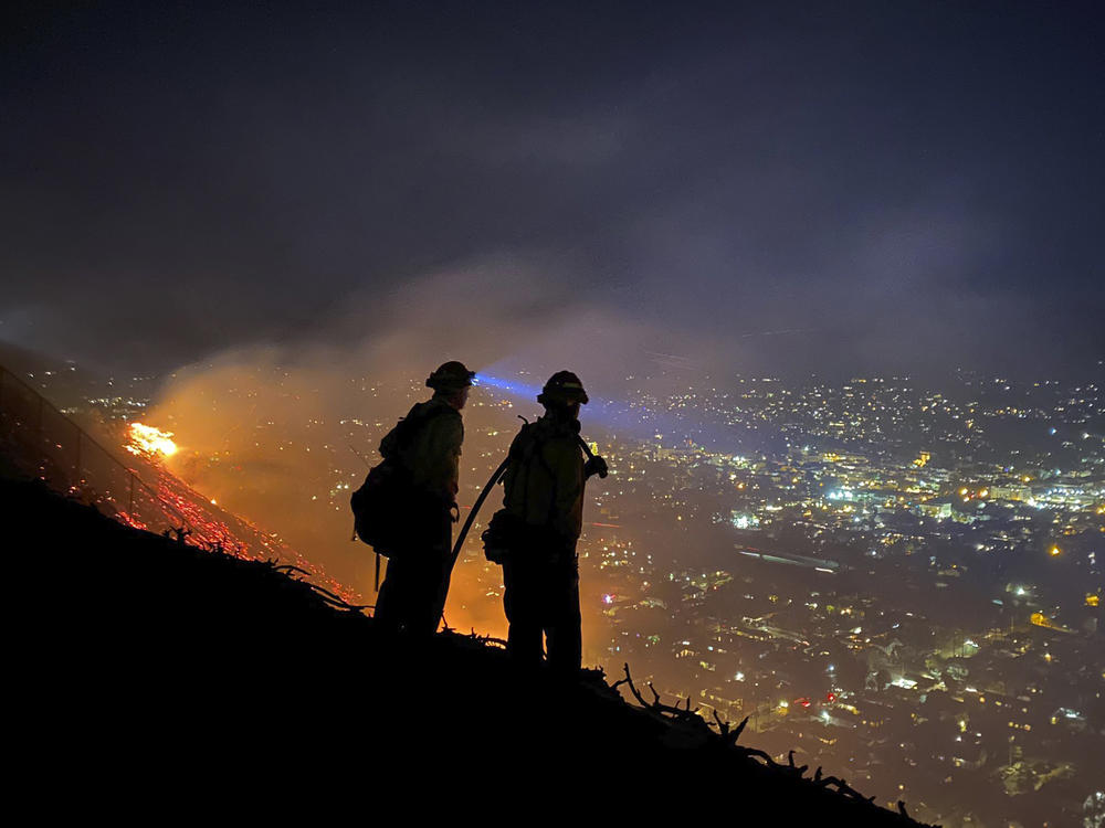 Firefighters battle a brush fire last week in Santa Barbara, Calif. Climate-driven droughts make large, destructive fires more likely around the world. Scientists warn that humans are on track to cause catastrophic global warming this century.