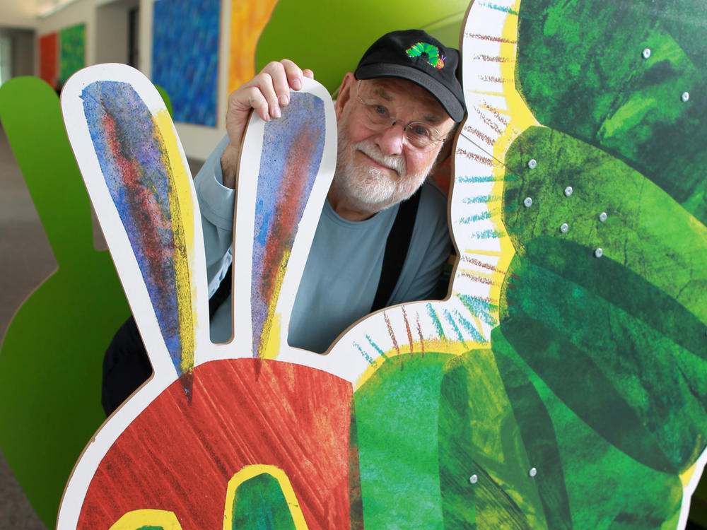 Eric Carle with a cutout of his famously hungry caterpillar at the Eric Carle Museum of Picture Book Art in Amherst, Mass.