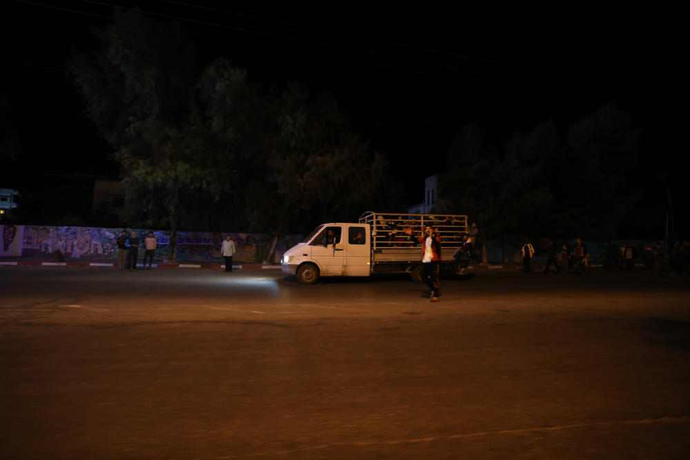 A truck carries several families evacuating from their homes in Beit Hanoun, a neighborhood in Gaza.