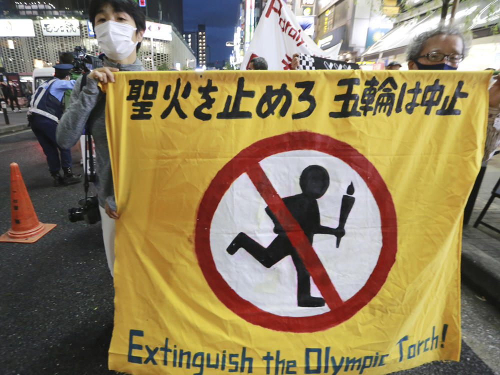 People carry a banner reading 