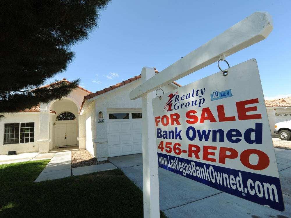 A house under foreclosure in Las Vegas displays a sign on Oct. 15, 2010, saying that it's now bank-owned. Sen. Sherrod Brown has vowed increased scrutiny of Wall Street banks, in part after a surge in foreclosures in his hometown in Ohio over a decade ago.