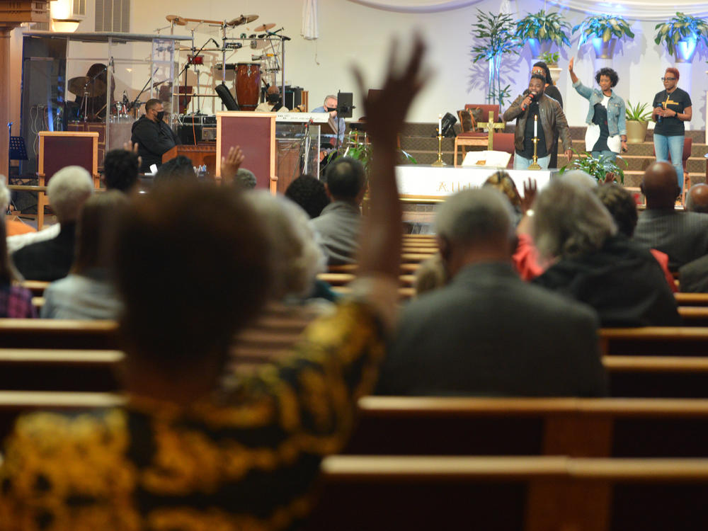 A quartet takes the place of a choir at a physically distanced service at St. James United Methodist in Kansas City.
