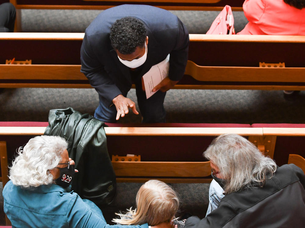 The Rev. Emanuel Cleaver III welcomes congregants to St. James United Methodist, where the COVID-19 pandemic paused in-person services for more than a year.