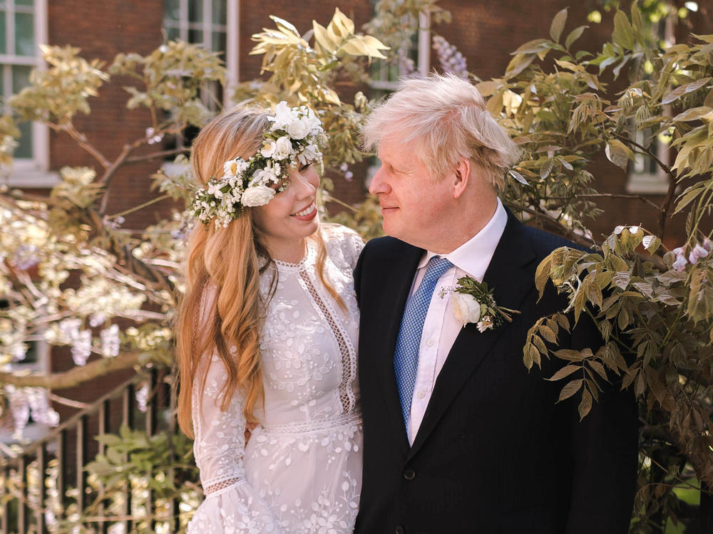 Prime Minister Boris Johnson poses with his wife Carrie Symonds in the garden of 10 Downing Street following their wedding at Westminster Cathedral on Saturday in London.