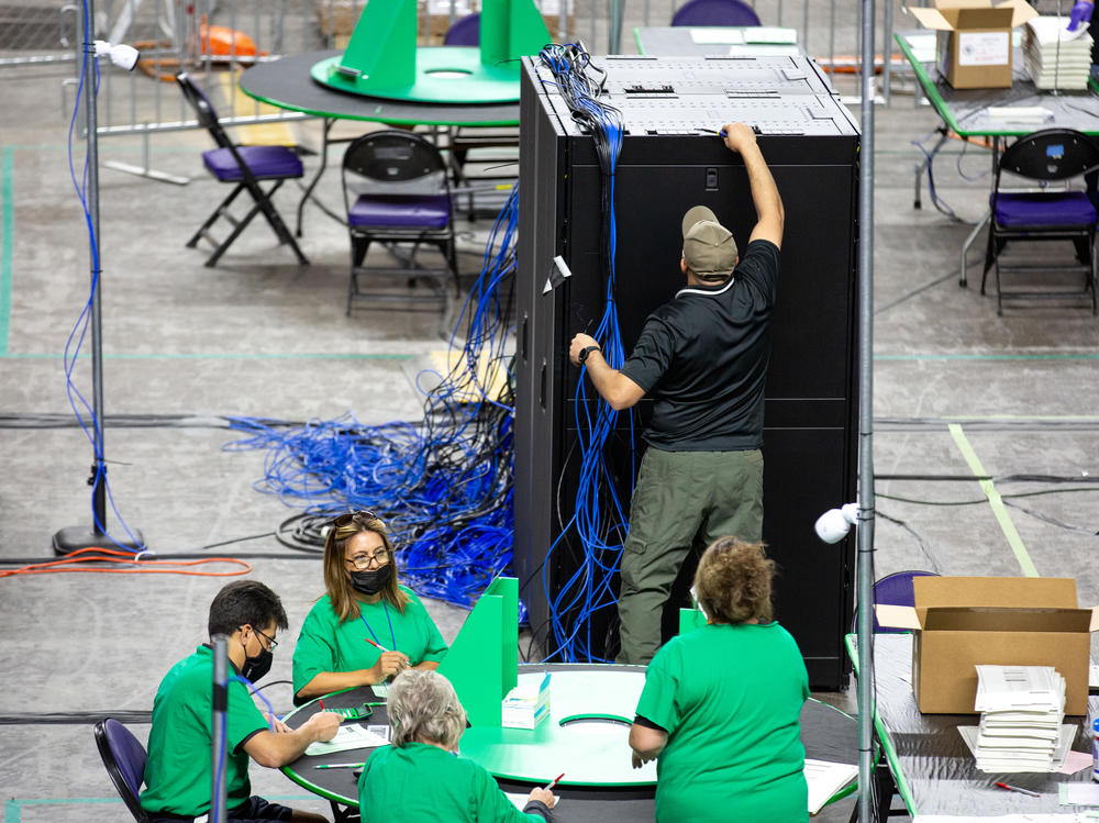 Contractors working for Cyber Ninjas, the company hired by the Republican-led Arizona state Senate, examine and recount ballots from the 2020 general election on May 3.