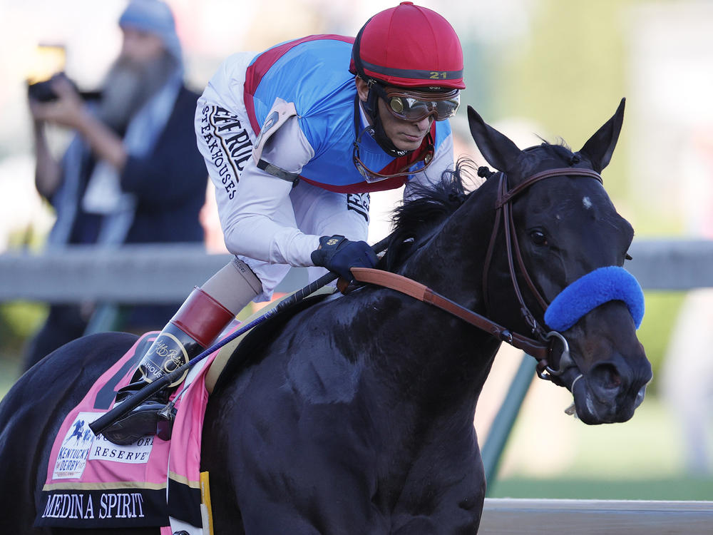 Medina Spirit, ridden by jockey John Velazquez, leads the field to the first turn during the Kentucky Derby on May 1 at Churchill Downs in Louisville, Ky. The colt has failed a second drug test following the race.
