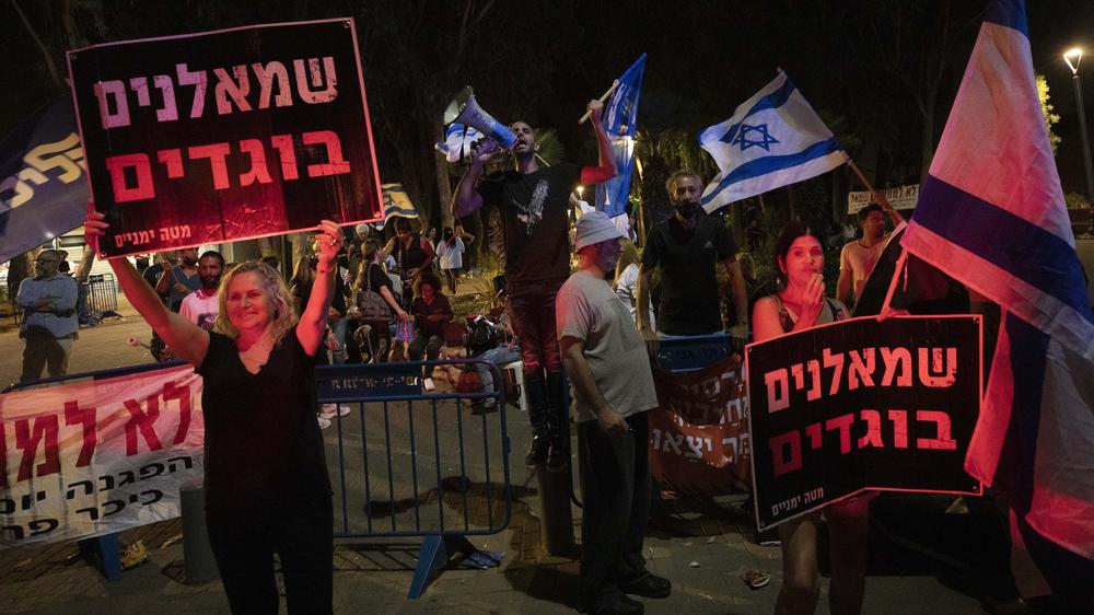 Right-wing activists demonstrate against the proposed coalition government in Tel Aviv, Israel, on Sunday. The signs read: 