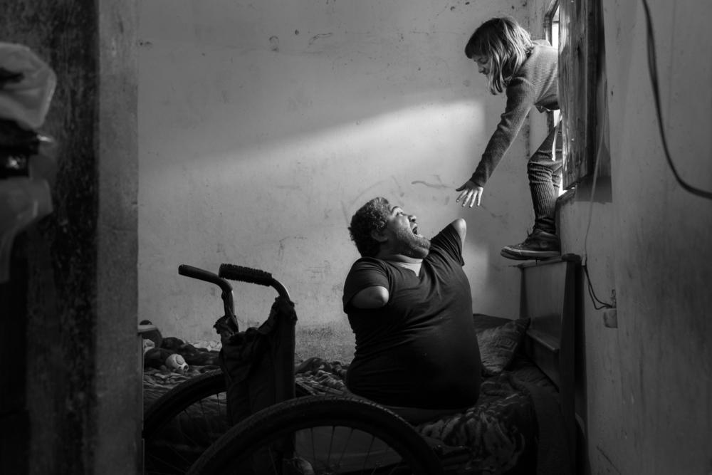 Jorge, age 40, plays with his 8-year-old daughter Ángeles in their house near Buenos Aires, Argentina. Asked what it is like to live through a pandemic, Jorge answered, 