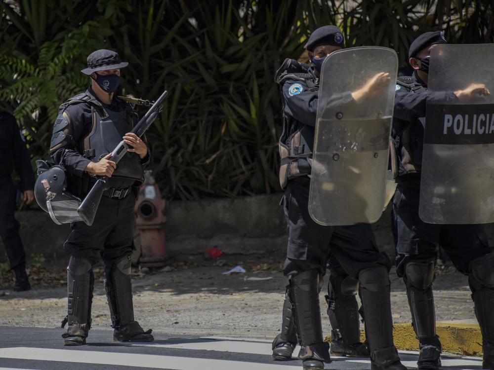 Riot police stand guard outside the house of Cristiana Chamorro, former director of the Violeta Barrios de Chamorro Foundation and pre-presidential candidate, in Managua on Wednesday.