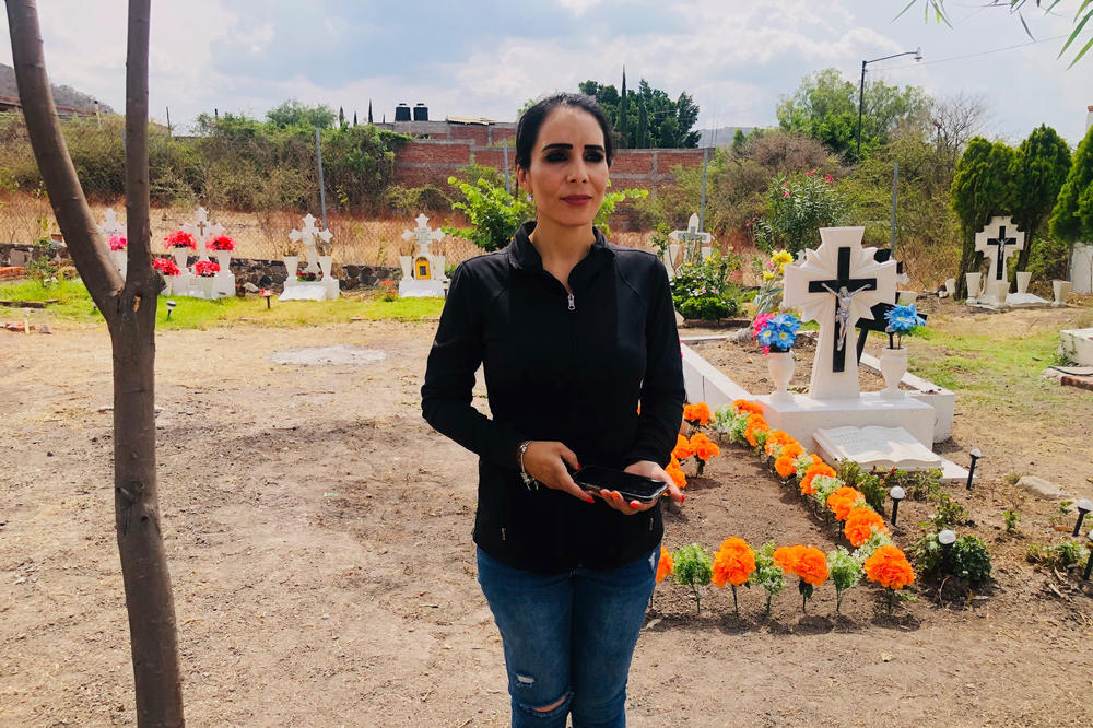 Alma Denisse Sánchez Barragán at her mother's grave near her ranch outside the city of Moroleón. Her mother, Alma Rosa Barragán Santiago, was a candidate who was killed by gunmen at a campaign rally. The daughter has taken her mother's place as a candidate.