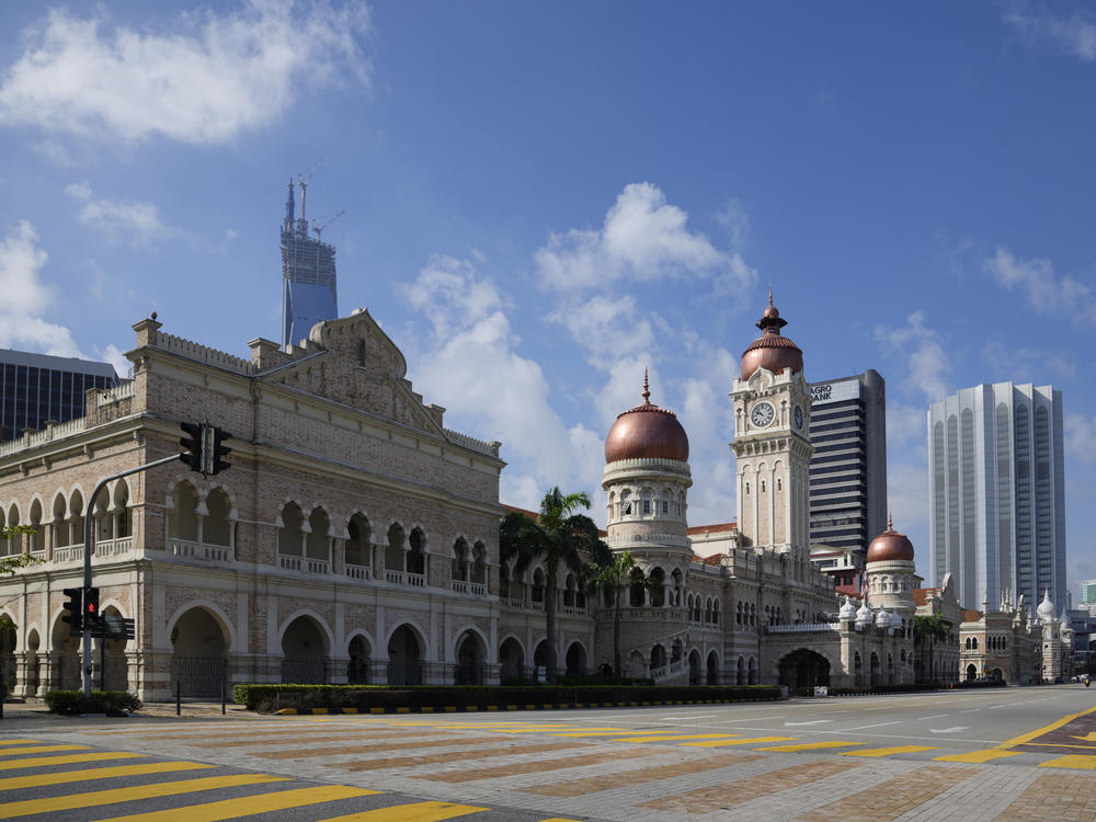 The roadway in front of Kuala Lumpur's Independence Square is empty on Tuesday, the first day of a two-week lockdown to try and curb a surge of infections that has overwhelmed the health care system.