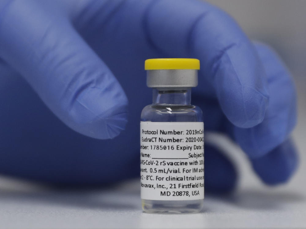 A vial of the experimental Novavax coronavirus vaccine is ready for use in a London study in 2020. Novavax's vaccine candidate contains a noninfectious bit of the virus — the spike protein — with a substance called an adjuvant added that helps the body generate a strong immune response.