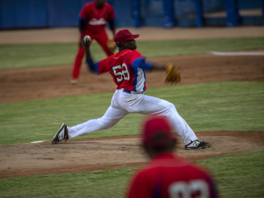 Cuba's pitcher Yoanni Yera Montalvo throws the ball during a training session at the Estadio Latinoamericano in Havana last month. Cuba's losses this week in Florida to Venezuela and Canada in Olympic baseball qualifying play means the team will not compete in the Summer Games.