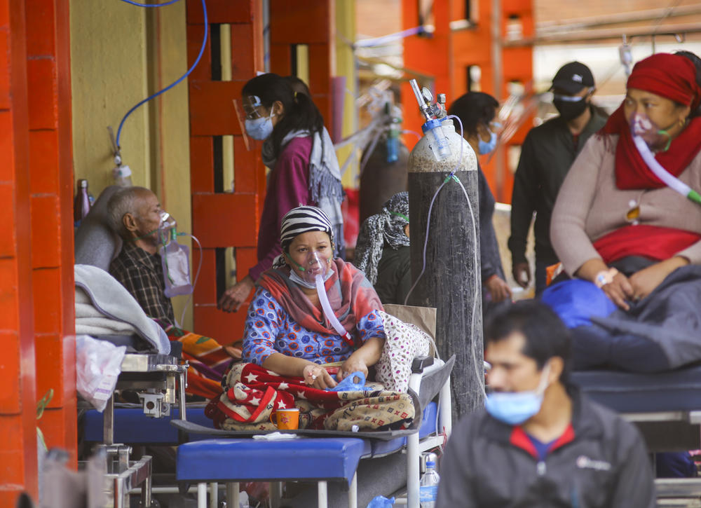 COVID-19 patients in Kathmandu receive oxygen as they wait outside a hospital for coronavirus patients that doesn't have enough beds for all those diagnosed. The photo was taken on May 13.