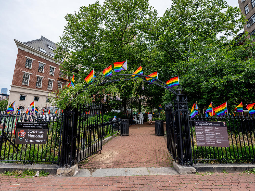 Pride flags decorate the Stonewall National Monument at Christopher Park in front of the Stonewall Inn. Many Pride events this year are more subdued due to pandemic precautions.
