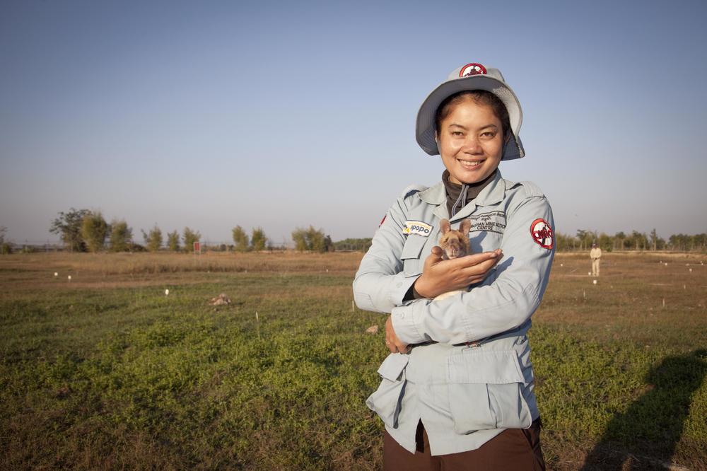 Magawa with his handler, Malen. The nonprofit APOPO uses positive reinforcement methods to train the rats.