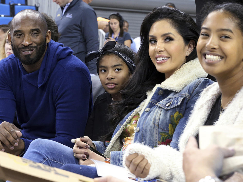 Basketball great Kobe Bryant (from left), daughter Gianna, wife Vanessa and daughter Natalia are seen before an NCAA college women's basketball game in 2017 in Los Angeles. Vanessa Bryant says Nike is making, without her consent, a shoe she designed in honor of her late daughter, Gianna.
