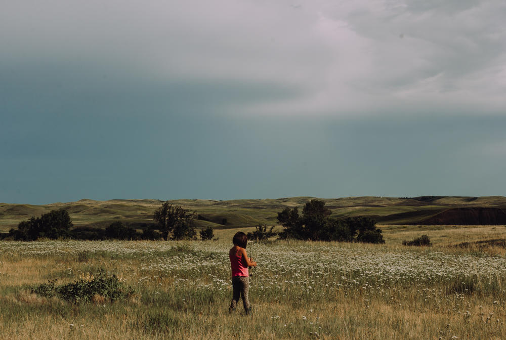 Born and raised on the Cheyenne River Reservation, a sovereign Lakota nation in South Dakota, Dawnee LeBeau is <em>Oóhenuŋpa Itázipčo</em> (two kettle and without bows) of the <em>Tetonwan Oyate</em> (people of the plains). After losing her father, she found comfort in doing things she did with him, like identifying plants. LeBeau was doing that with family when she made this image of her niece.
