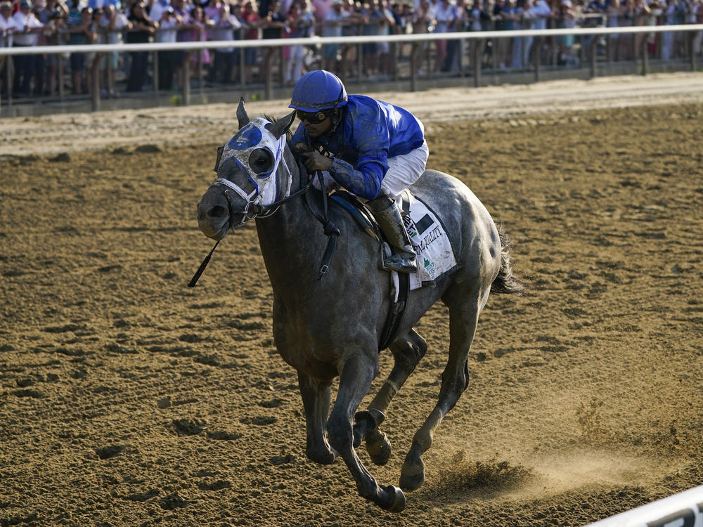 Essential Quality, with jockey Luis Saez, crosses the finish line to win the 153rd running of the Belmont Stakes horse race on Saturday at Belmont Park in Elmont, N.Y.