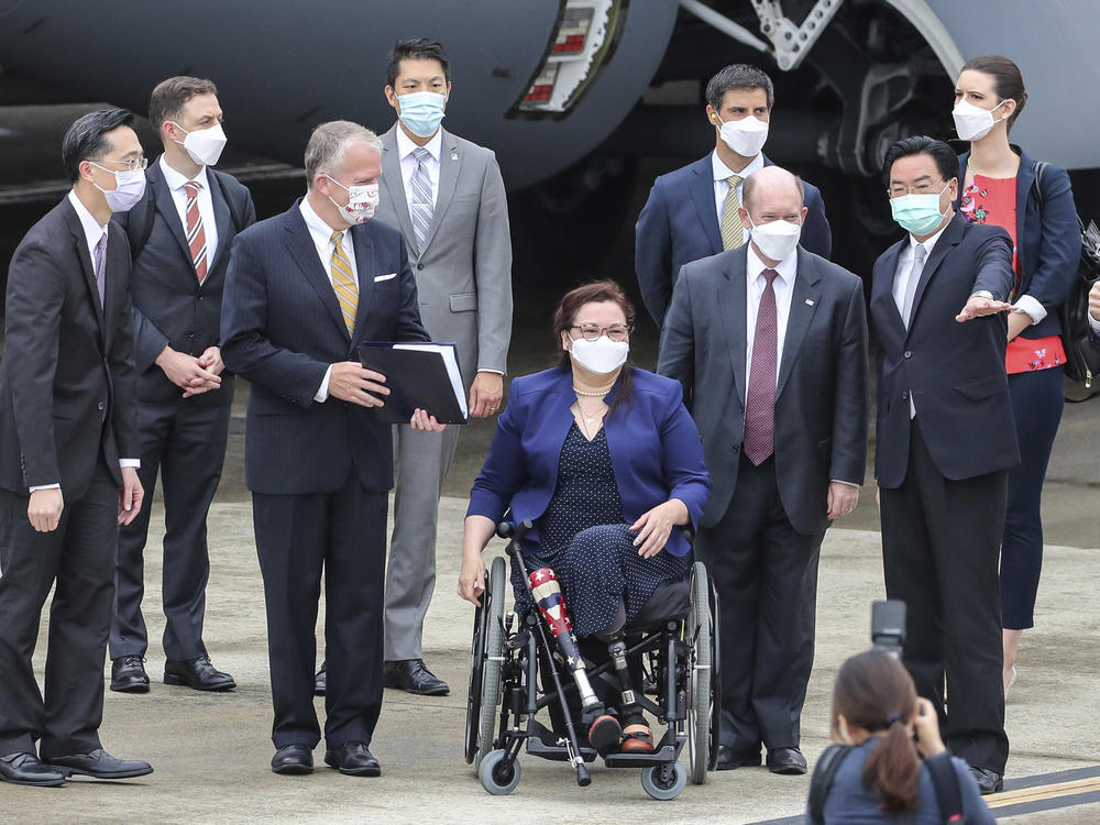 Taiwan's Foreign Minister Joseph Wu (second right) welcomes U.S. senators upon their arrival at the Songshan Airport in Taipei on Sunday. To his right are Democratic Sen. Christopher Coons of Delaware, a member of the Foreign Relations Committee, Democratic Sen. Tammy Duckworth of Illinois and Republican Sen. Dan Sullivan of Alaska, members of the Armed Services Committee.