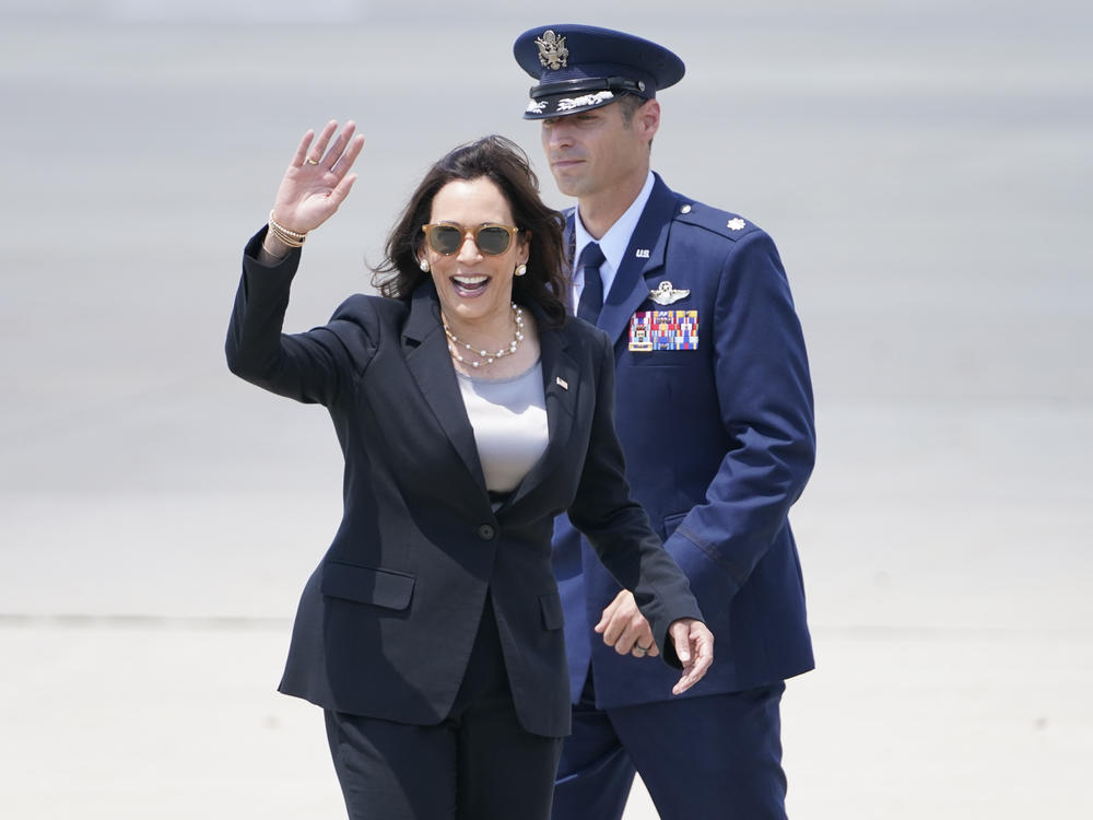 Vice President Harris waves before boarding Air Force Two for Guatemala. The plane had to return to Joint Base Andrews shortly after takeoff because of what a Harris aide called 