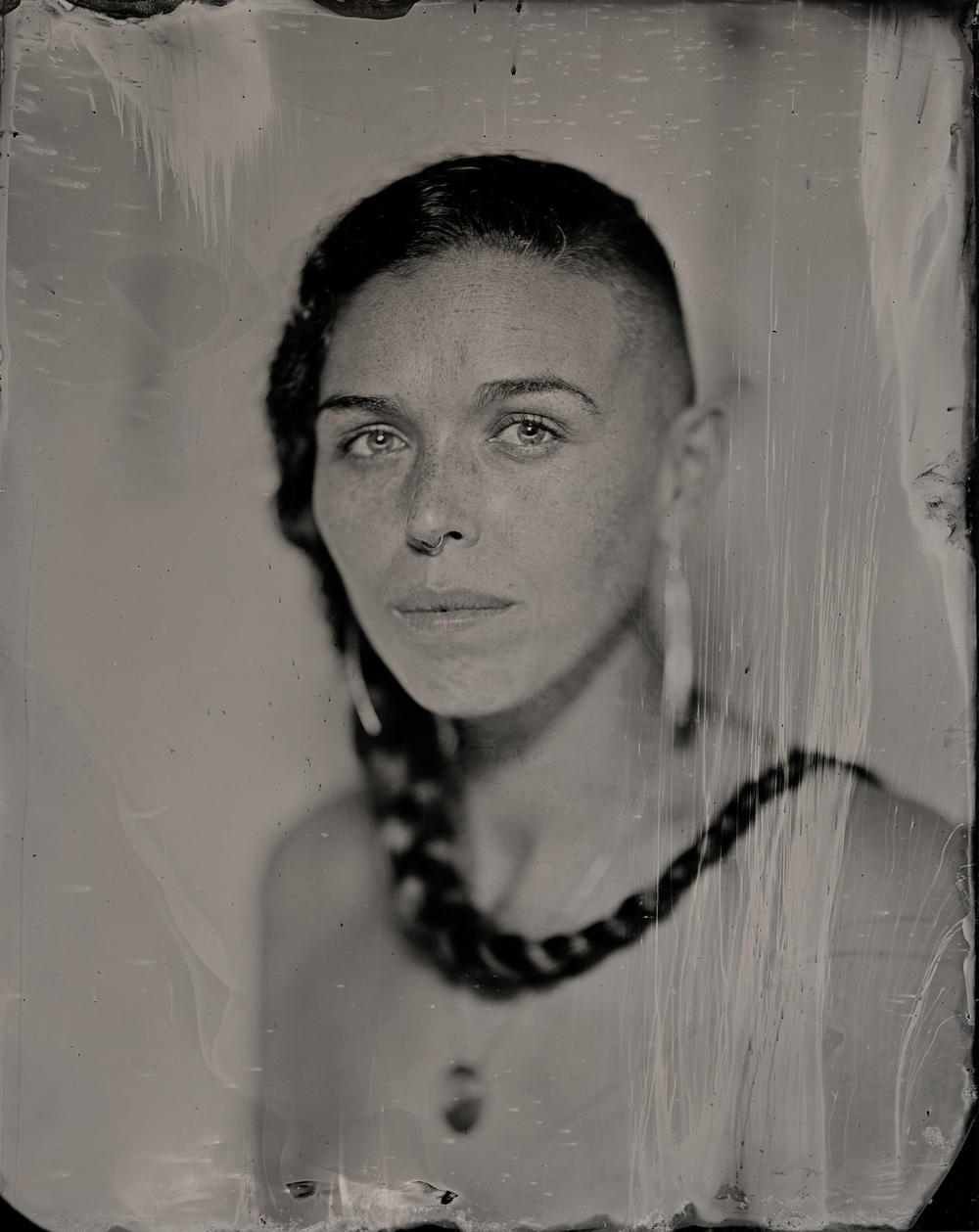 The work of Kali Spitzer (Kaska Dena & Jewish) embraces the stories of BIPOC, queer and trans people, creating representations that are self-determined. This traditional tintype photo of Larissa Lorraine Grieves (Nisga'a, Gitxsan, Cree, Blackfoot from the Pikuni Nation, Metis, Swedish, Irish and Scottish) was made in 2021.