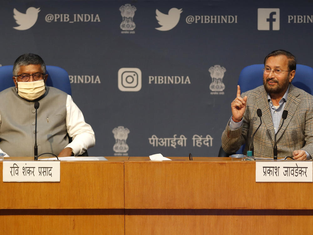 India's Information Technology Minister Ravi Shankar Prasad (left) and Information and Broadcasting Minister Prakash Javadekar announce new regulations for social media companies and streaming websites in New Delhi in February. India's government has warned Twitter to comply with the country's new social media regulations, which critics say give the government more power to police online content.