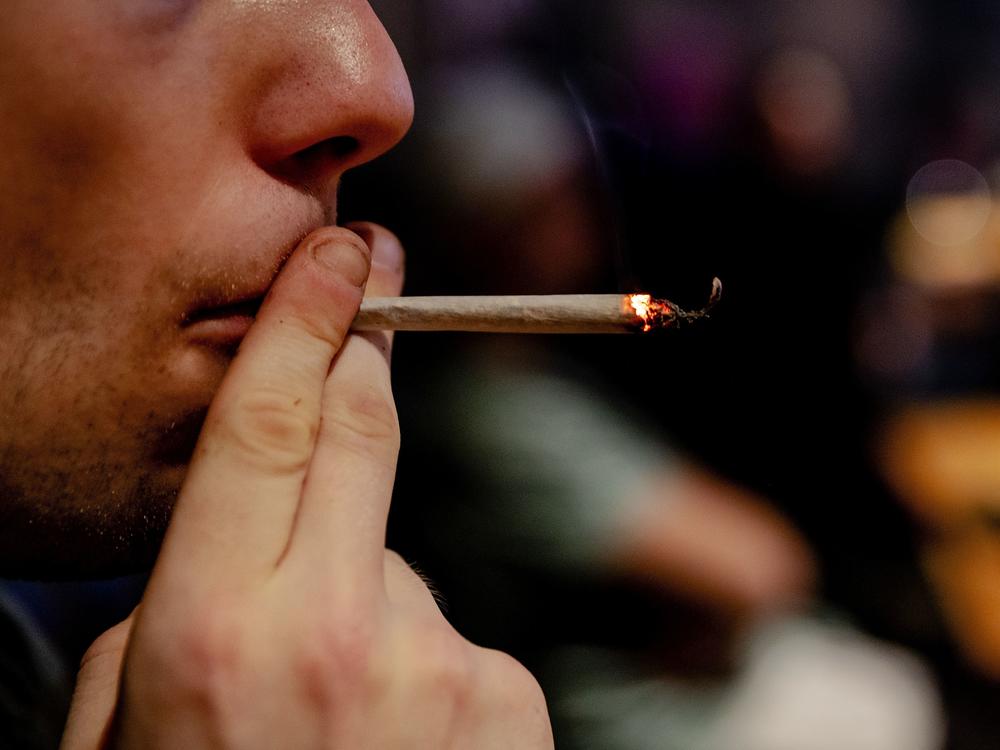 Washington is offering free, pre-rolled joints to adults who get the COVID-19 vaccine. Here, a person smokes a joint in The Netherlands.