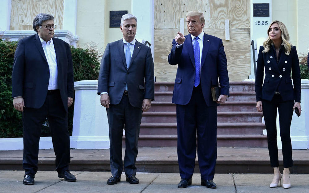 Trump stands outside St. John's Church on June 1, 2020, along with members of his administration, Attorney General William Barr (far left), White House national security adviser Robert O'Brien (second from left) and White House press secretary Kayleigh McEnany.