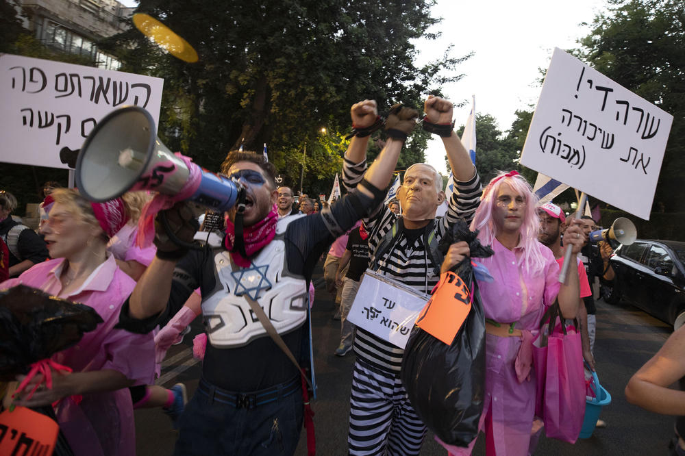 Israeli protesters hold signs and chant slogans during a demonstration against Israeli Prime Minister Benjamin Netanyahu as they march from the Knesset, Israel's parliament, to the prime minister's residence in Jerusalem earlier this month.