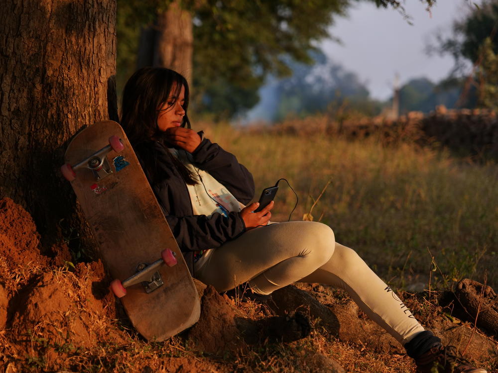 Asha Gond, 21, with her skateboard. She tried the sport when a skatepark was set up in her rural village and is now one of India's top female skateboarders.