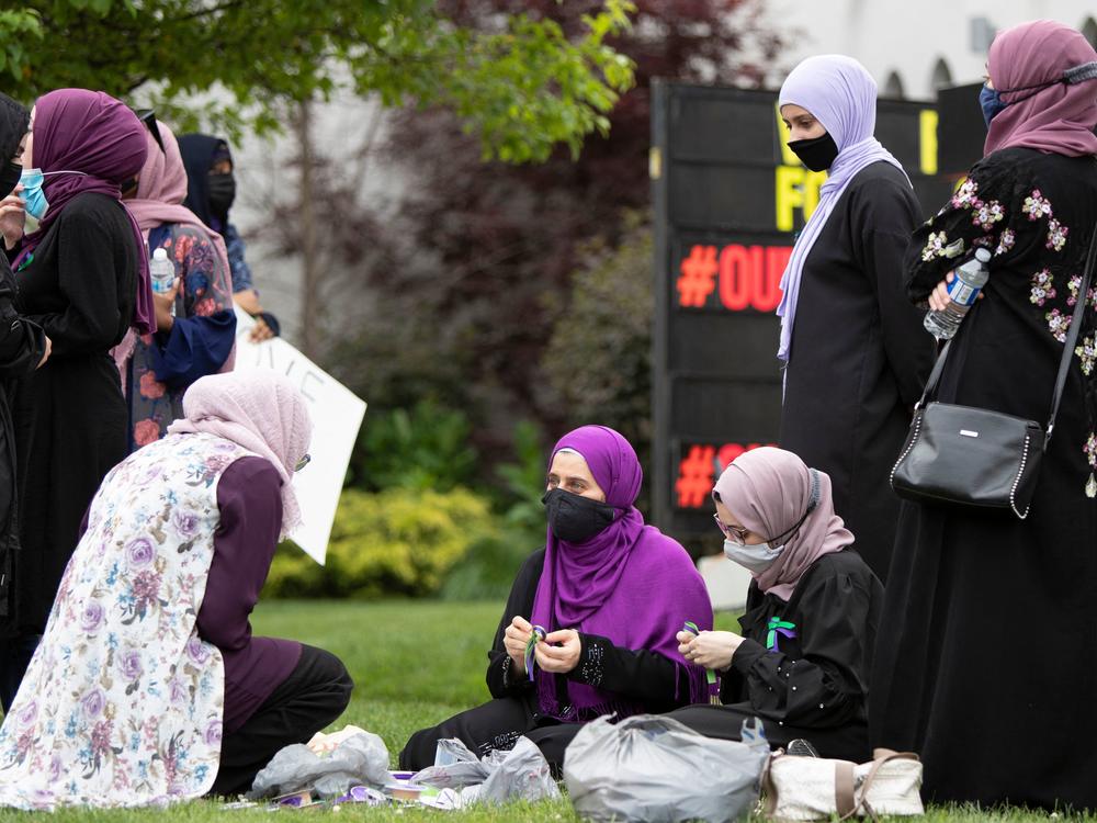 Friend's of ninth-grader Yumna make ribbons on the lawn of the London Muslim Mosque prior to a vigil.