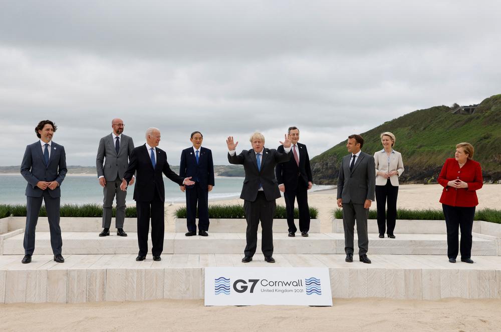The G-7 leaders gather for the traditional group photo ahead of Friday's talks.