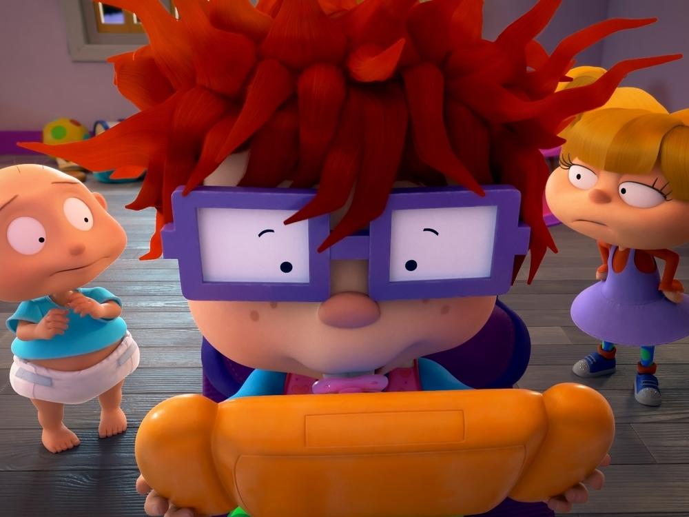Pictured: Tommy Dewey as Stu Pickles, Nancy Cartwright as Chuckie Finster and Cheryl Chase as Anjelica Pickles of the Paramount+ series <em>Rugrats</em>.