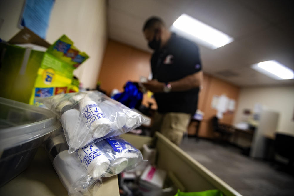 At his office in the Lynn Community Health Center, Will packs a backpack with sterile syringes, Narcan and safety kits to distribute to drug users on the streets to keep them safe from the risks associated with drug use.