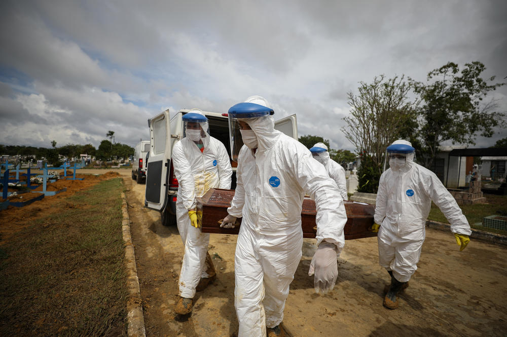 Workers in protective suits carry the coffin of a person who died of COVID-19 for burial at a cemetery in Manaus. In this Amazonian city alone, 4,430 people died within the first two months of the year.