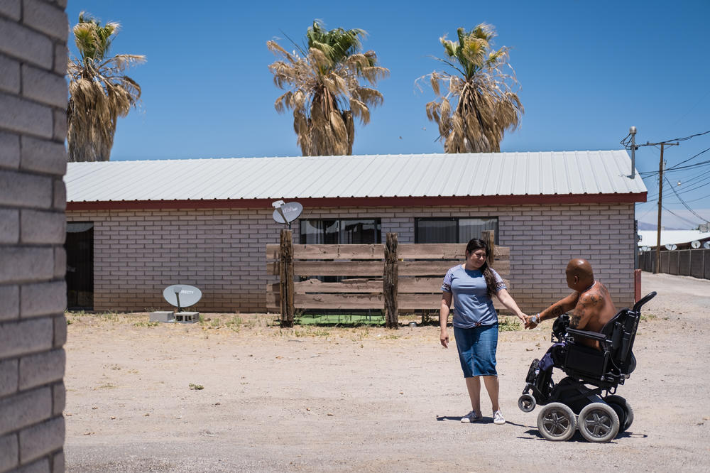 Alicia and Matt Lammers walk outside of their home in New Mexico.