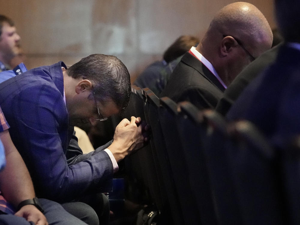 A man prays during the executive committee plenary meeting at the Southern Baptist Convention's annual gathering Monday in Nashville, Tenn.
