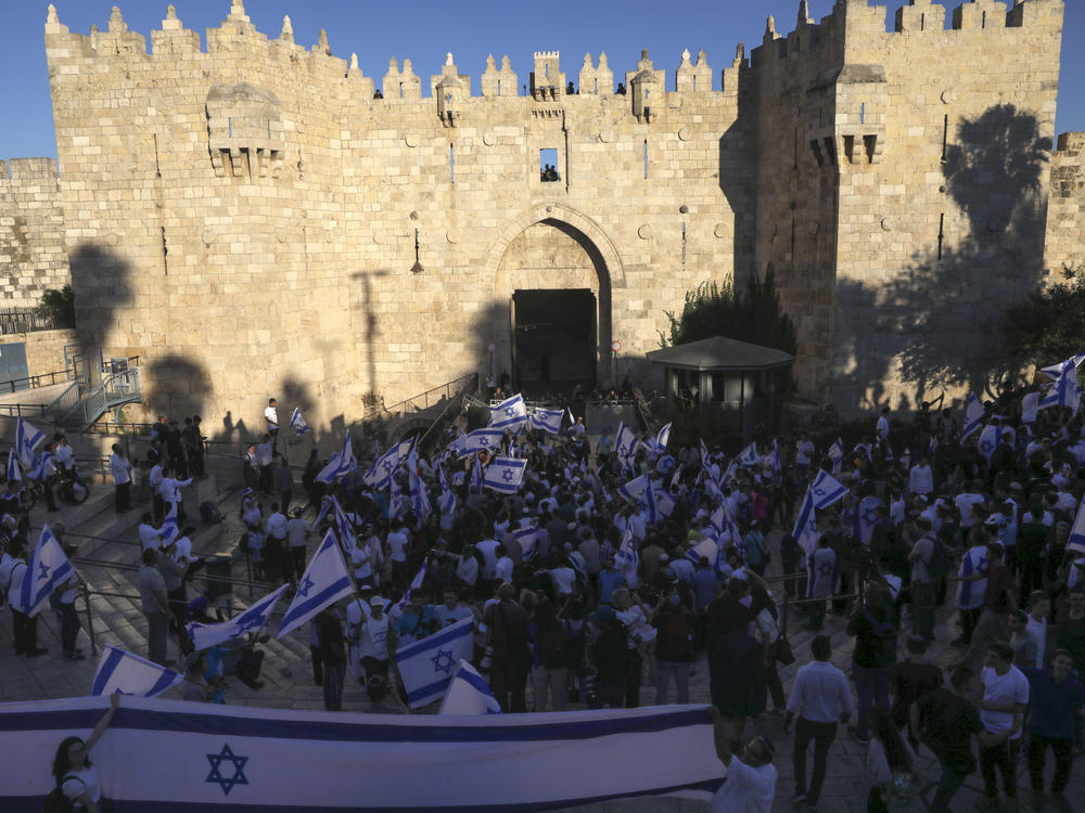Jewish ultranationalists take part in a flag-waving march Tuesday next to the Damascus Gate, outside Jerusalem's Old City.