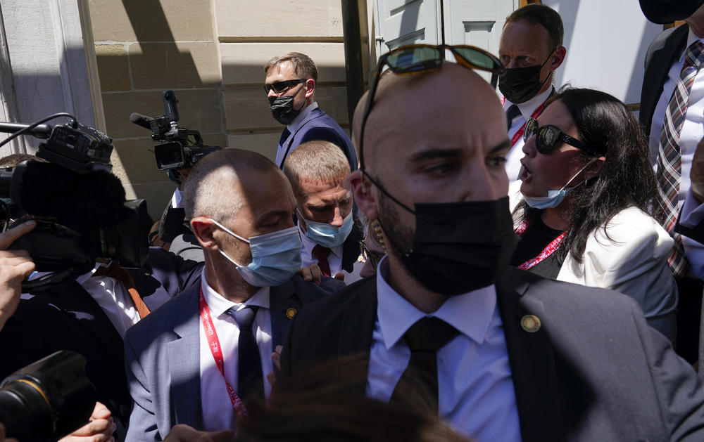 Security personnel corral members of the press  covering President Biden's meeting with Russian President Vladimir Putin on Wednesday in Geneva.
