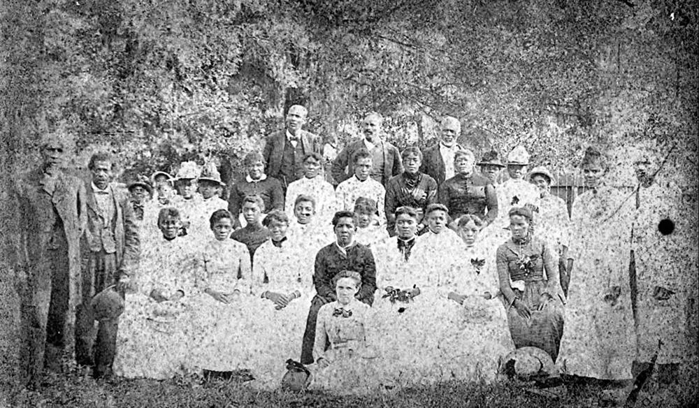 A group photograph of 31 people at a Juneteenth celebration in Emancipation Park in Houston's Fourth Ward in 1880.