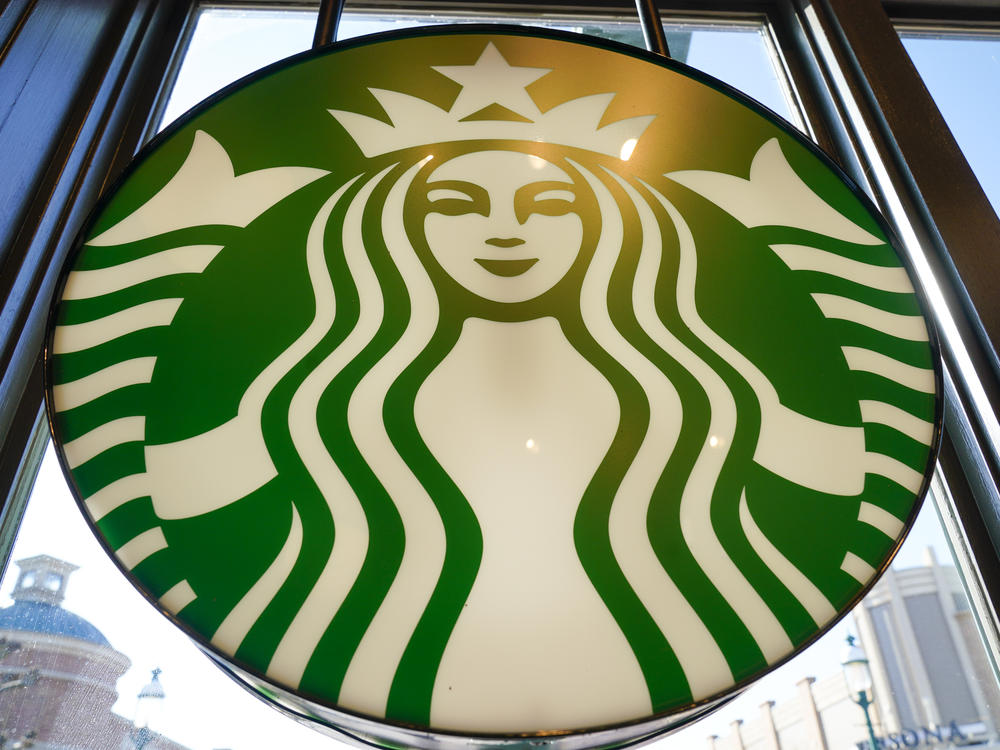 There are now nearly 33,000 Starbucks locations around the world. Here, a Starbucks logo hangs in the window in Homestead, Pa.