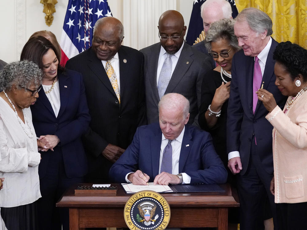 President Biden signs the Juneteenth National Independence Day Act in the East Room of the White House on Thursday.