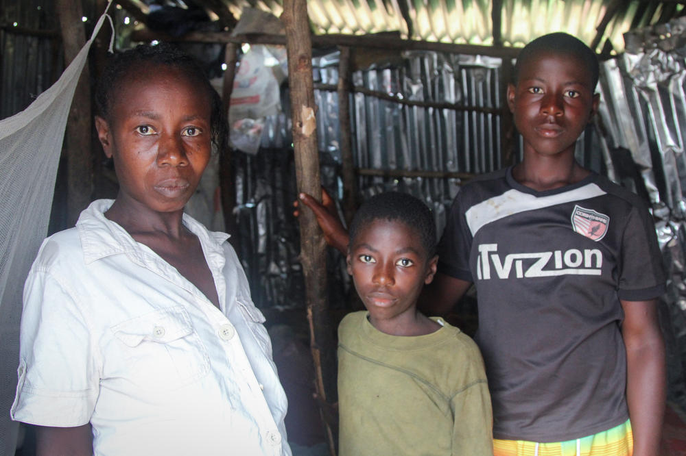 Bintu Tarawaly with sons Clifford, 9, and Sahr, 14. With his dad out of the picture, Sahr is working to support the family.