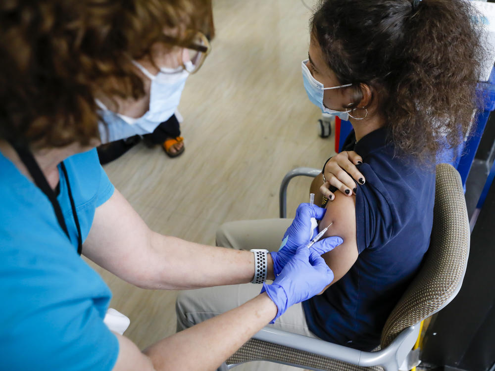 A teen gets a dose of Pfizer's COVID-19 vaccine last month at Holtz Children's Hospital in Miami. Nearly 7 million U.S. teens and preteens (ages 12 through 17) have received at least one dose of a COVID-19 vaccine so far, the CDC says.