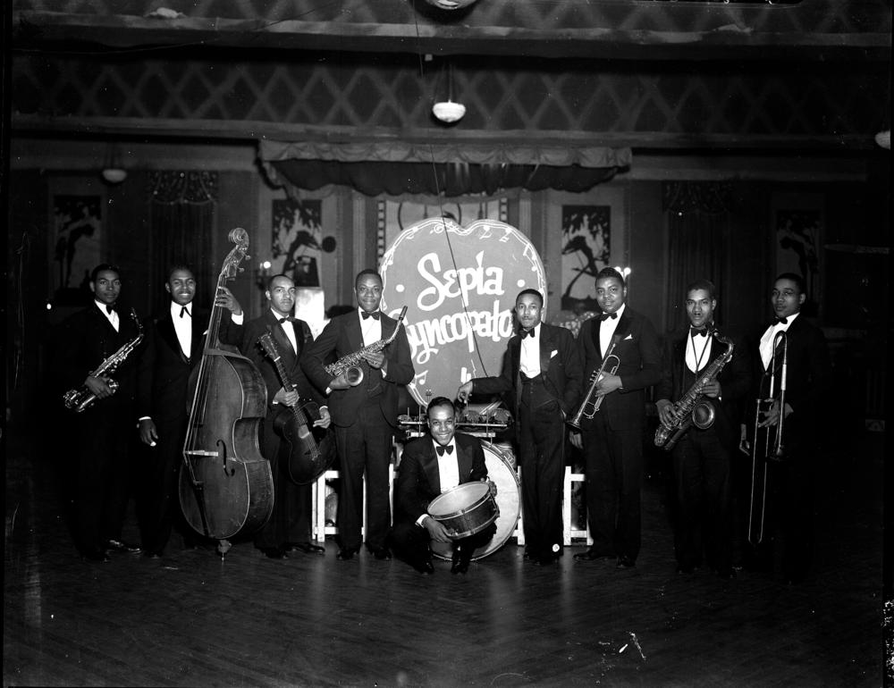 Group portrait of band Sepia Syncopaters with their instruments.