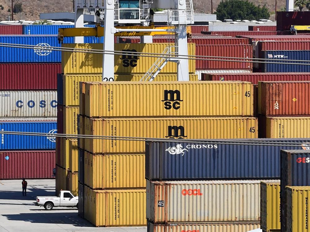 Shipping containers are stacked high at the Port of Los Angeles in April. Supply chain disruptions are hitting small-business owners across the United States.