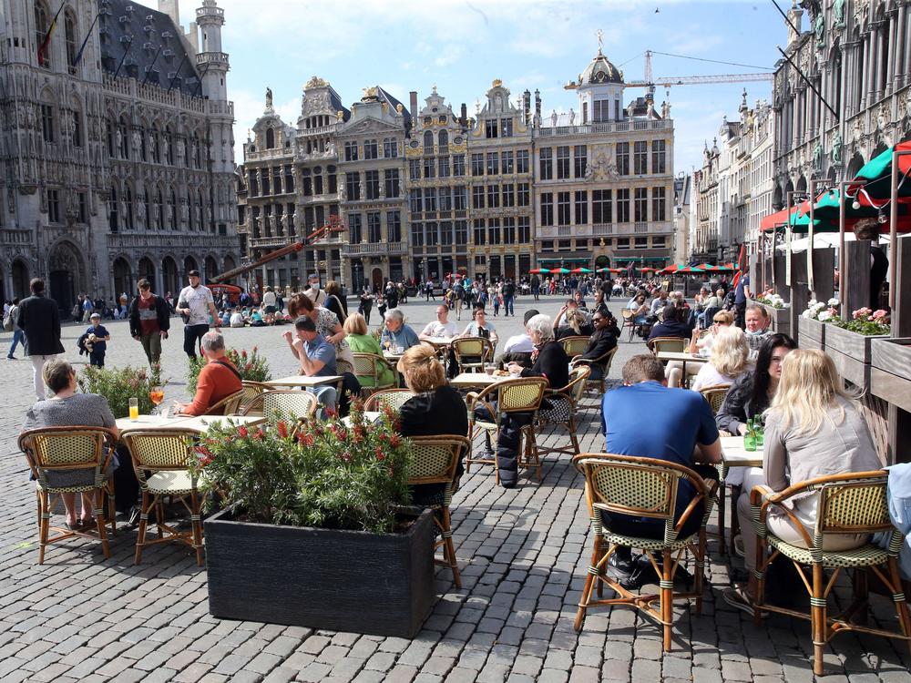 People enjoy the May sunshine from the cafe terraces of Brussels' Grand Place. On Friday, European Union added the United States to the list of countries whose citizens and residents should be allowed to travel freely within the bloc.