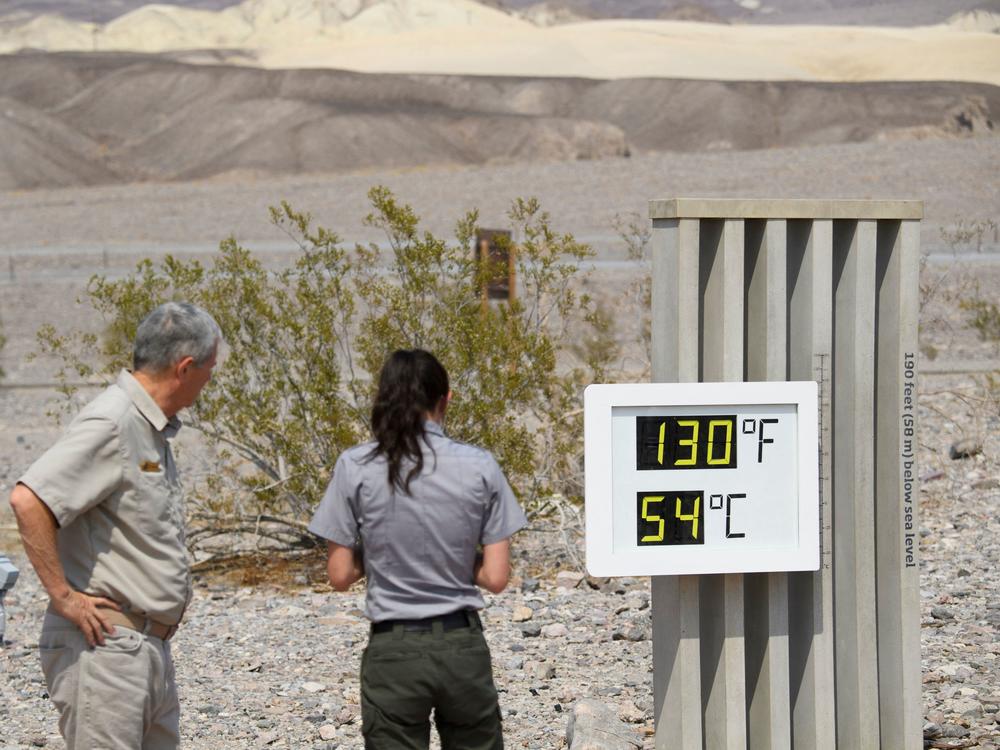Visitors feel the heat in California's Death Valley earlier this week. This record-setting heat wave's remarkable power, reach and unusually early appearance is giving meteorologists yet more cause for concern about extreme weather in an era of climate change.