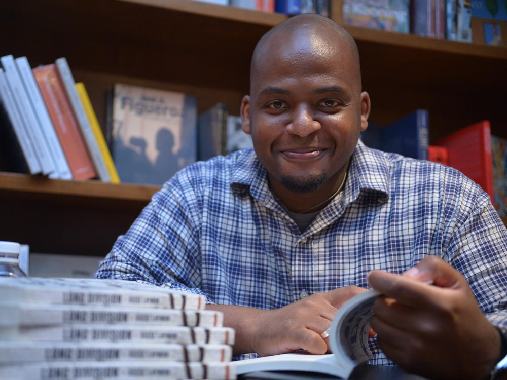 Author Kiese Laymon signs copies of his book <em>Long Division</em> at Books and Books on July 11, 2013 in Coral Gables, Fla.